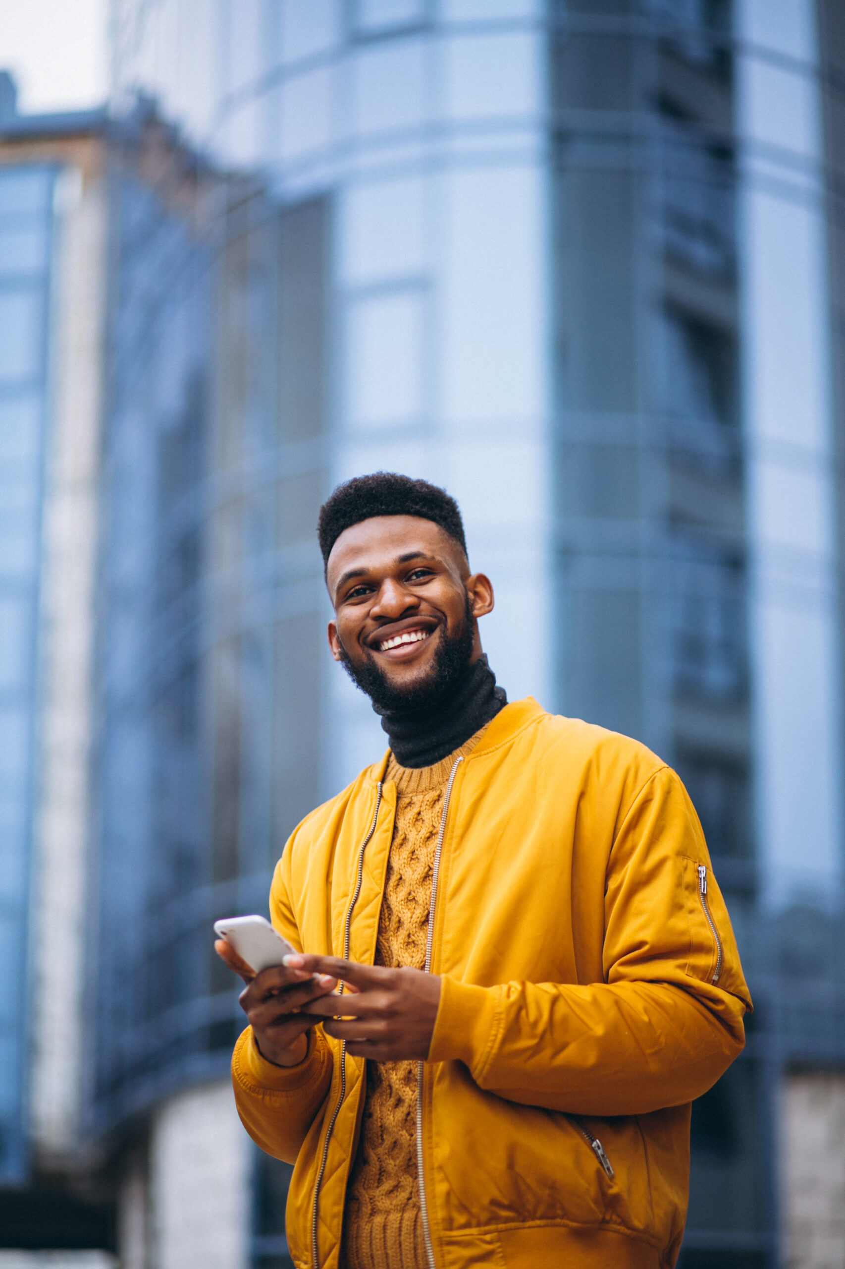 Home african american student walking in the street and talking on the phone
